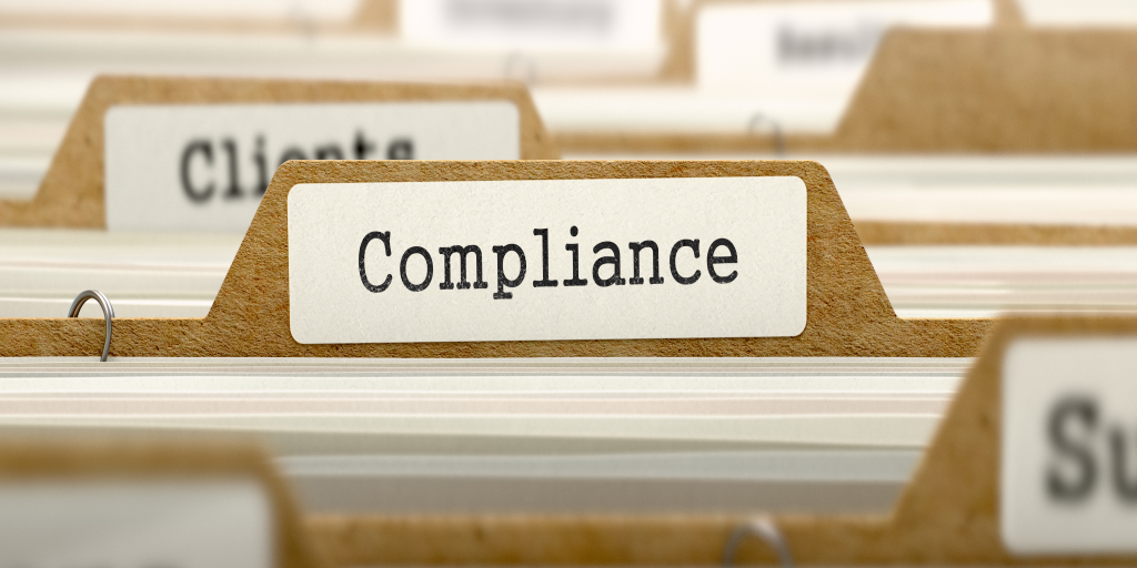 A folder with the word Compliance written on it. 