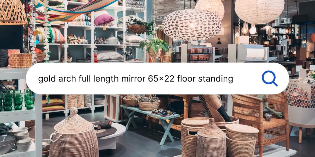 A view of Home Furniture section is physical store. A search bar with words 'Gold Arch Full Length Mirror 65x22 floor standing written it is placed at the center of the picture. 