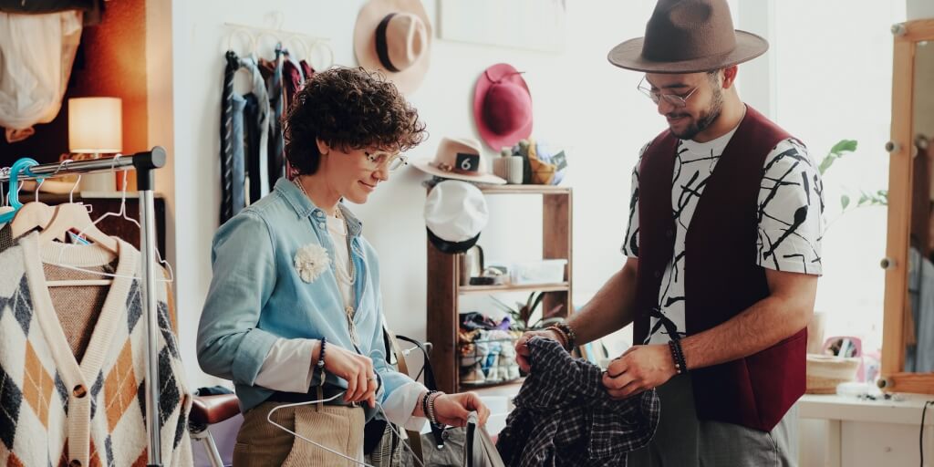 Young man and woman are looking at second-hand products in a brick-and-mortar store.