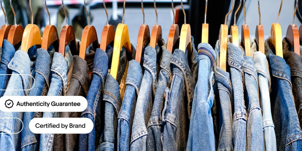 A view of multiple denim jackets on hangers. 